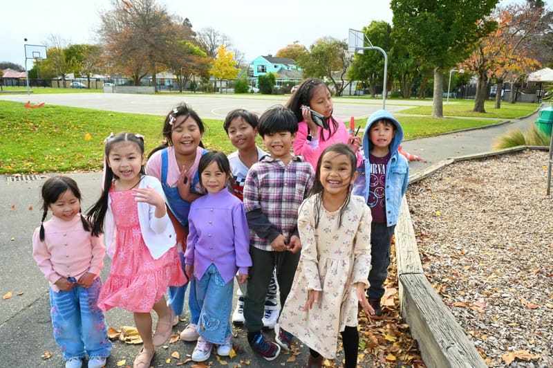 Children smiling together outdoors at The Avenue Village NZ in Christchurch